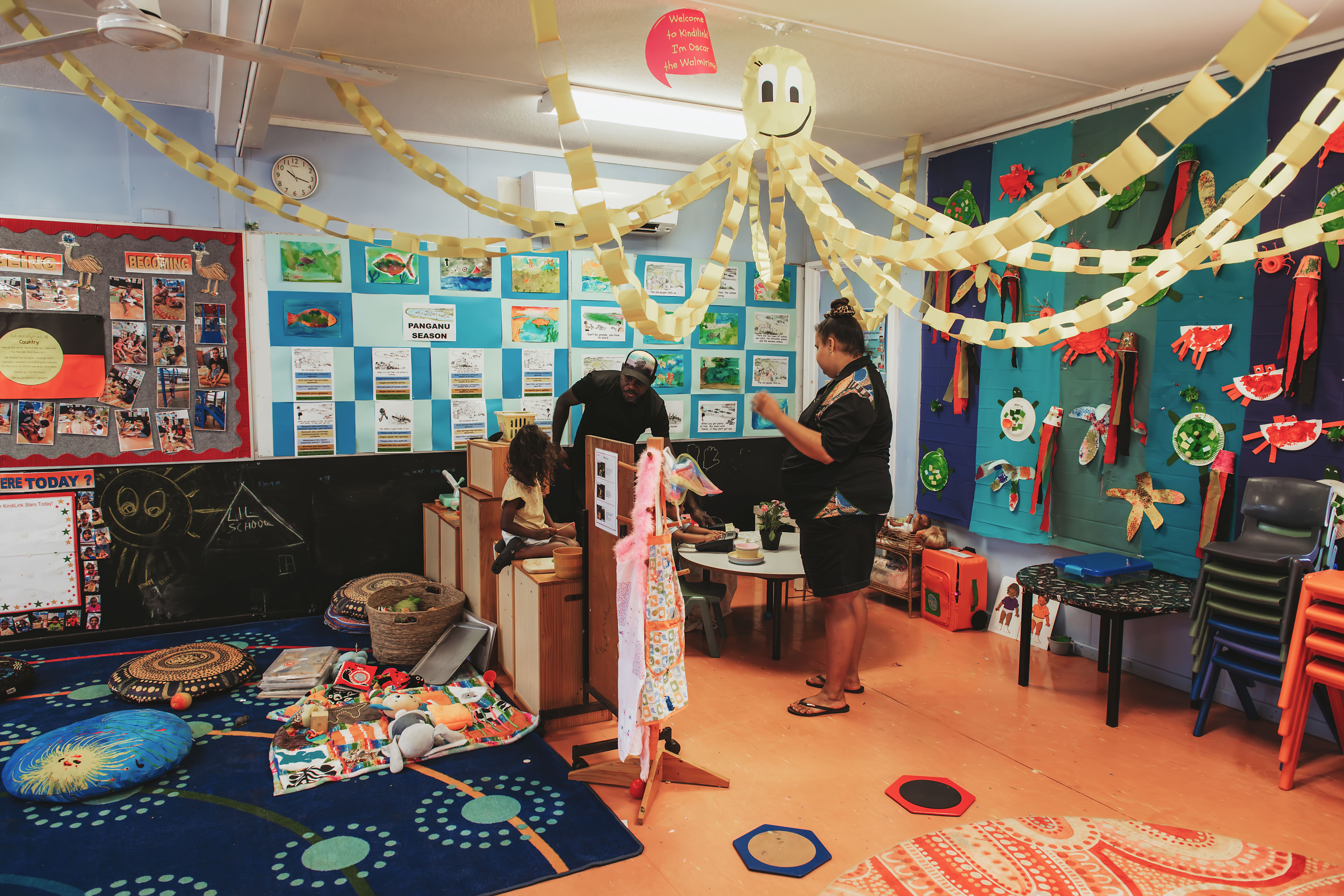 Children and carers in the classroom decorated with a large paper octopus hanging from the ceiling